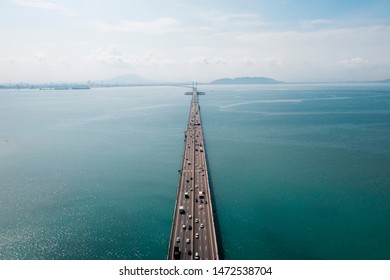 Aerial top view. Drone photo of Penang water bridge with moving traffic. Road image transportation background concept.