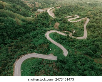 Aerial top view drone photo over green mountains with white fog floating and paths exciting steep road way of travel at Phu Thap Boek ,Phetchabun,Thailand - Powered by Shutterstock