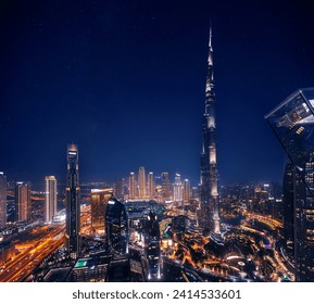 Aerial top view Dubai, night amazing skyline cityscape with illuminated skyscrapers, neon color. Modern downtown United Arab Emirates, sky with stars. - Powered by Shutterstock