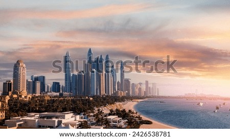 Aerial top view Dubai, panoramic of Marina and JBR sand beaches, sunset time. Downtown of UAE with modern futuristic skyscraper.