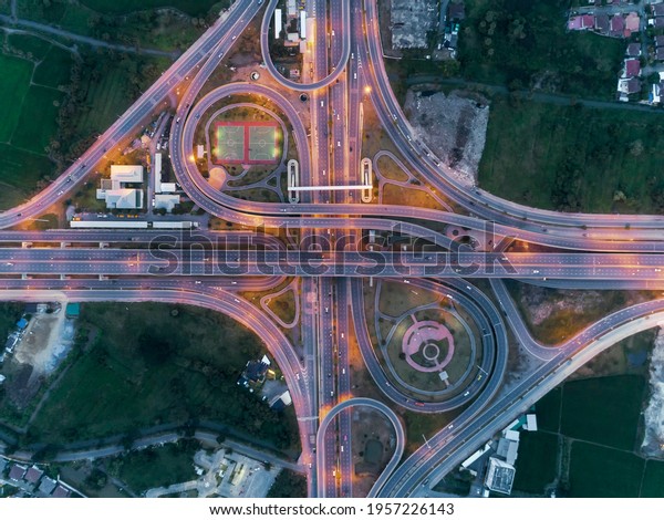 aerial\
top view, Expressway road intersection, traffic in bangkok at\
night, Chaiyaphruek road, nonthaburi, \
thailand.