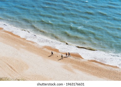 Aerial Top View Family Walking On The Beach On A Sunny Day. Calming And Enjoying Life. Emotional Wellness. Happiness Is In Simple Things. Copy Space