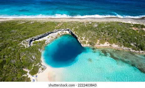 Aerial Top View Of The Famous Dean's Blue Hole With The Connecting Turquoise Lagoon Next To The Blue Ocean, Long Island, Bahamas