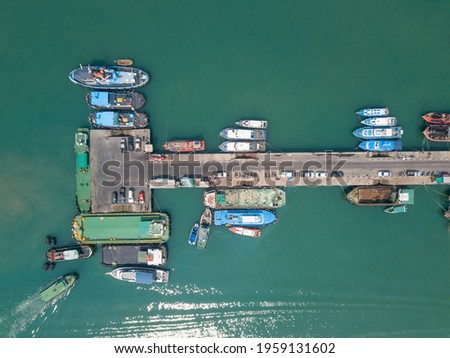 Aerial top view of fisherman dock which has many ships anchoring for transport supplies inland