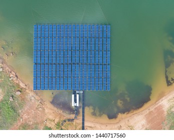 aerial top view of Floating Solar Energy Panels on a lake - solar power farm.