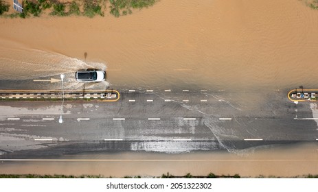 Aerial top view of Flooded the village and Country road with car, View from above shot by drone
