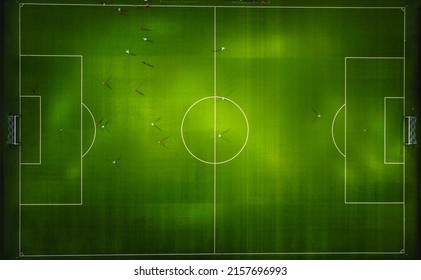 Aerial top view from flying drone of the football field in the evening. - Powered by Shutterstock