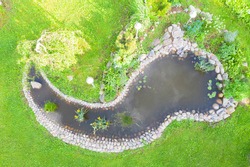 Aerial Top View Garden Pond. Garden Fish Pond. Pond On Natural Landscape. Water Garden Natural Pool. Exterior Of A Private Garden. Pool With Rocks