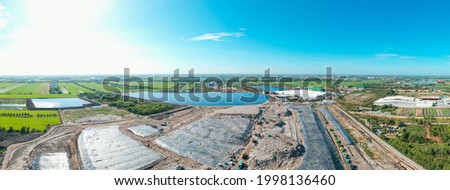 Aerial top view of Giant garbage mountain in trash dump or open landfill, Trash trucks dump waste products polluting in an trash dump, Group Workers hands sorting garbage for recycling