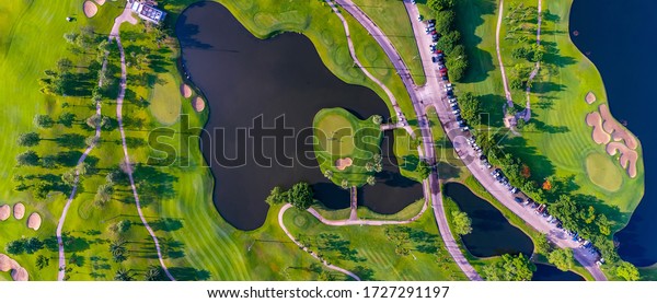 Aerial top view of golf field
landscape with sunrise view in the morning shot. Bangkok
Thailand