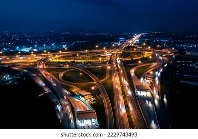 Aerial top view of Highway road junctions. Rush hour traffic on multiple highways in city at night. Transportation and cargo delivery in the industrial city. - Shutterstock ID 2229743493