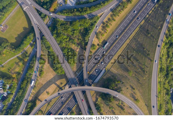 Aerial top View of\
Highway Road Junctions during day time. The Intersecting Freeway\
Road Overpass 