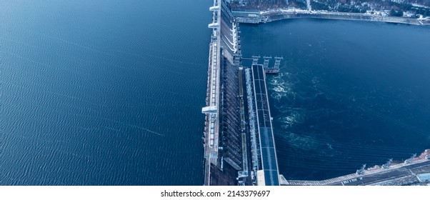 Aerial top view hydroelectric dam, water discharge through locks, blue color banner industrial concept. - Shutterstock ID 2143379697