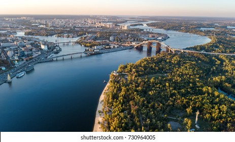 Aerial top view of Kyiv skyline, Dnieper river and Truchaniv island from above, sunset in Kiev city, Ukraine
