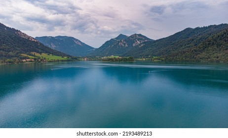 Aerial top view of lake shore in south Germany, Schliersee in Bavarian Alps seen from above - Powered by Shutterstock