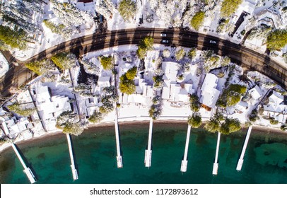 Aerial Top View Of Lake Tahoe Lakefront Homes Covered In Snow During Winter