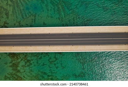 Aerial top view of a long bridge above a sea near Trogir and Split in Croatia. Isolated by the green sea water. - Powered by Shutterstock