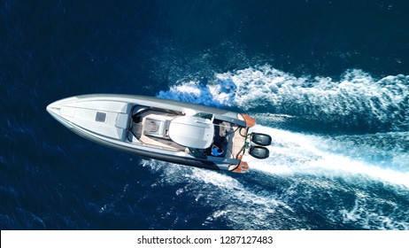 Aerial top view luxury inflatable rib speed boat cruising in mediterranean deep blue sea