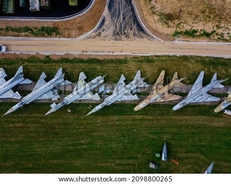Aerial top view of military aircrafts in the airfield.
