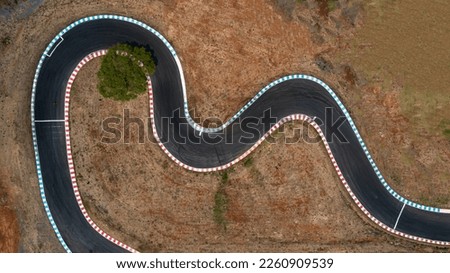Aerial top view motorsport race asphalt circuit motor racing track, Race track curve, Curving race track view from above, Aerial view car race asphalt track and curve.