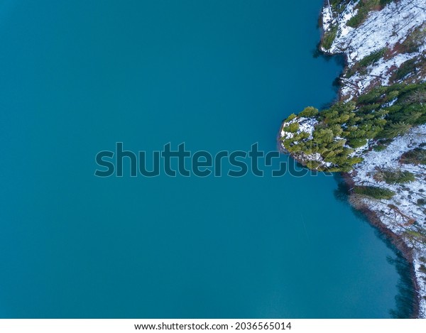 Aerial top view of mountain glacial lake Ritsa\
in Abkhazia at winter season. Beautiful mountain landscape from\
drone. Abkhazia.