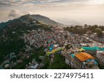 Aerial top view of Muree village, Islamabad with residential local houses and fog mist, nature trees, Pakistan in urban city town in Asia, buildings.