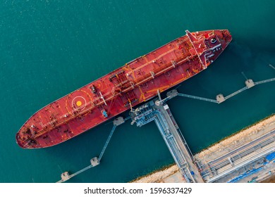 Aerial top view. Oil ship tanker and lpg ship at industrial port of business logistic transportation sea freight, Crude oil loading and uploading to Port of Singapore - import export