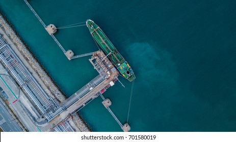 Aerial top view oil tanker ship under cargo operations, Import export business and transportation by tanker business logistic.