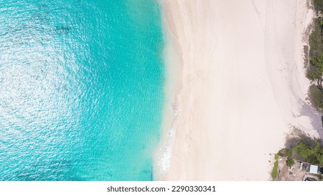 Aerial top view on nature landscape view of beautiful tropical clean sandy beach and soft blue ocean. Aerial top-down drone view. - Powered by Shutterstock