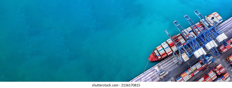 Aerial top view over international containers cargo ship at industrial import-export port prepare to load containers with big container loader ship vessel. global transportation and logistic business. - Shutterstock ID 2136170815