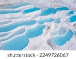 Aerial top view Pamukkale Turkey travertine pools, nature terraces with blue water.