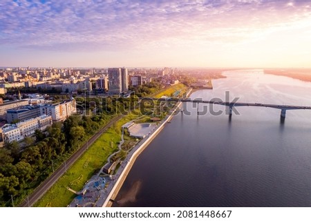 Aerial top view panorama city Perm and central embankment of Kama river Russia, sunset drone photo.