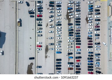 Aerial top view of parking lot with many cars from above, transportation and urban concept. Helicopter drone shot.