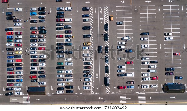 Aerial top view of parking lot with\
many cars from above, transportation and urban\
concept\
