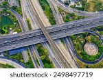 Aerial top view of railway tracks, Road traffic an important infrastructure with moving cars and railway tracks on which the train rides in Bangkok Thailand.