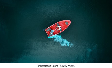 Aerial Top View. Red Boat On The Lake, Top View. Two Young Peopl