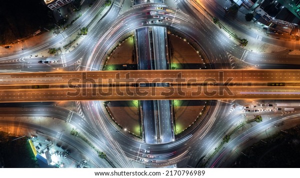 Aerial top view\
road roundabout interchange in city at night, Aerial view of\
highway and overpass in city at\
night.