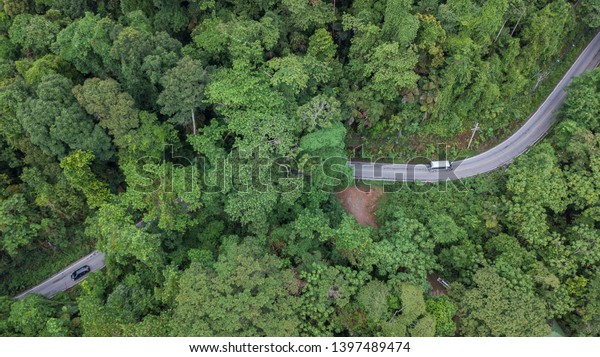 Aerial top view top view of\
the road through the forest at Koh Chang national park, Trad,\
Thailand