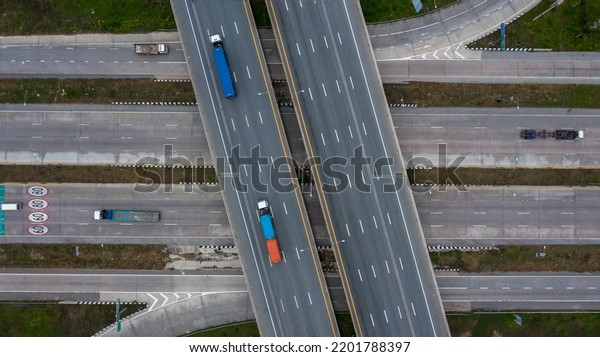 Aerial top view road traffic\
interchange in city, Aerial view of highway and overpass in city,\
Expressway top view, Road traffic an important\
infrastructure.