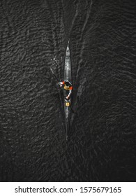 Aerial Top View Rower Training On The River In A Kayak. Black Water.