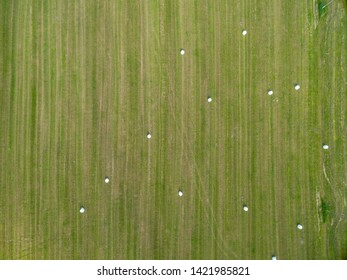 Aerial Top View Rural Field With The Harvest, Hay In Summer. Photo In Belarus. Nature From A Bird's Eye View