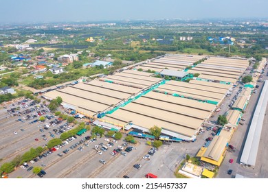 Aerial Top View Of Sanam Luang Street Market , Green Roof Tops, Horse Shoe Shape Drive Thru And Parking Area. Tents With Retail Shops.