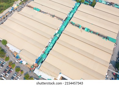 Aerial Top View Of Sanam Luang Street Market , Green Roof Tops, Horse Shoe Shape Drive Thru And Parking Area. Tents With Retail Shops.