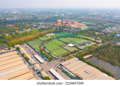 Aerial Top View Of Sanam Luang Street Market , Green Roof Tops, Horse Shoe Shape Drive Thru And Parking Area. Tents With Retail Shops.