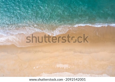
aerial top view sea waves seamless loop on the white sand beach. 
Wave after wave swept towards the shore. 
green sea, white bubble waves,and clear sand landscape. Paradise beach.