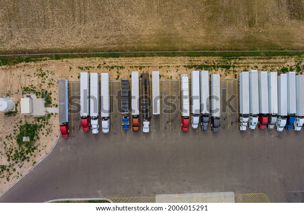 Aerial top view semi truck with cargo trailer\
car parking of truck rest area\
dock