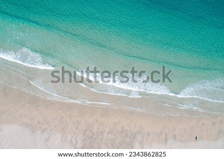aerial top view of the shore of a turquoise water beach