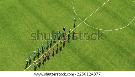Aerial Top View Shot of Soccer Championship Match Beginning. Two Professional Football Teams Enter Stadium Field Where they Will Compete for the Champion Status. Start of the Major League Tournament