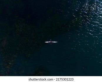 Aerial Top View Of A Small Group Of People Sea Kayaking