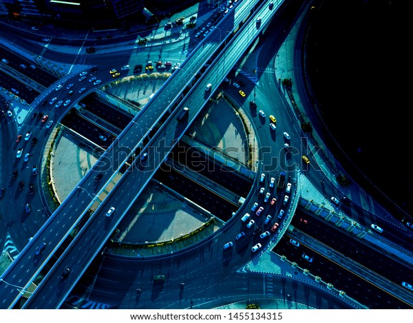 Aerial top view of\
Smart transportation with Expressway, Road and Roundabout, busy\
highway traffic night time. Important infrastructure with traffic\
light.